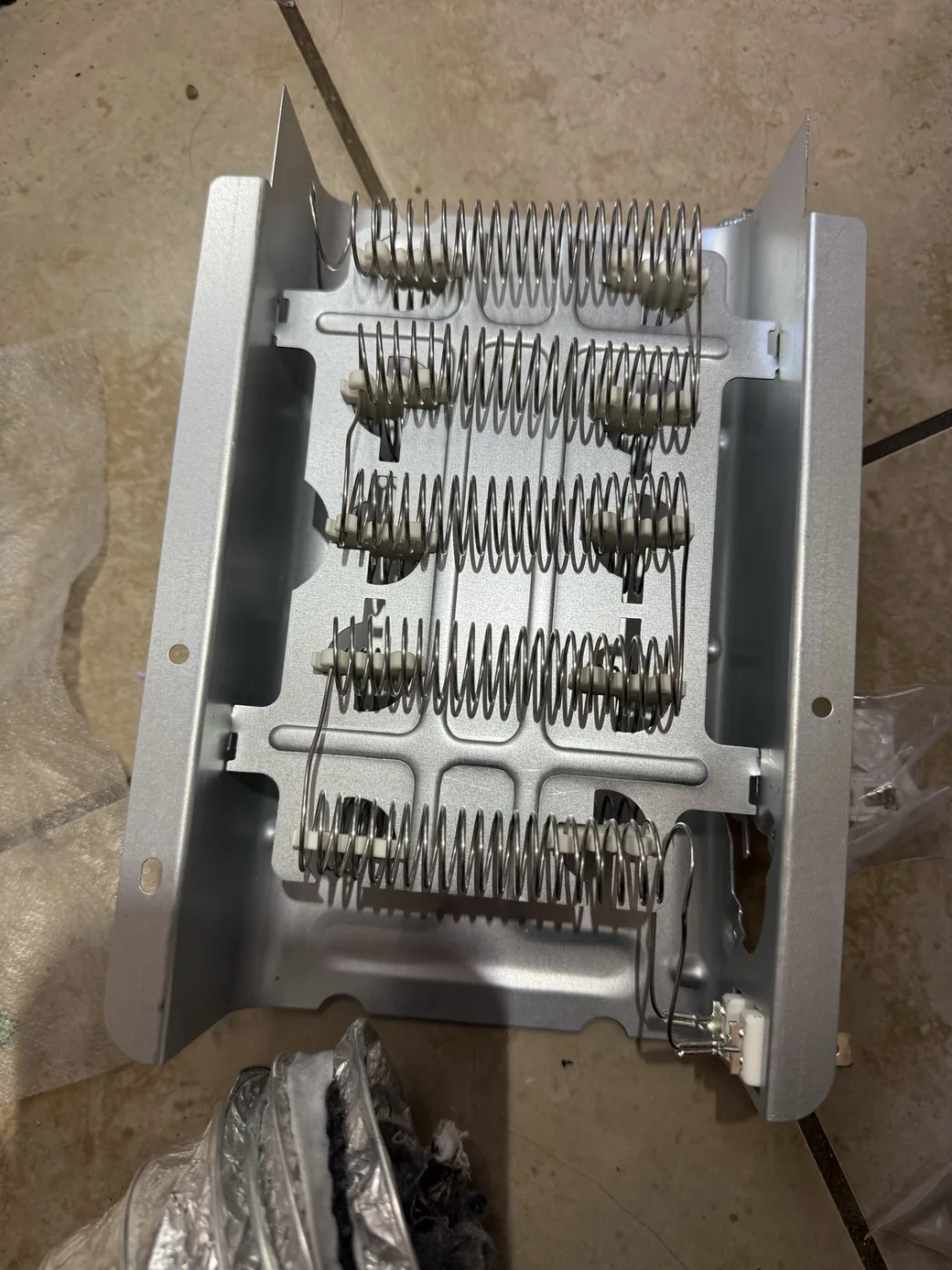 An electric heating assembly with exposed coiled elements